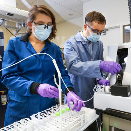 Santa Jansone-Popova, left, and Ilja Popovs quantify rare-earth element concentrations in liquid samples using a spectroscopy instrument. Credit: Genevieve Martin/ORNL, U.S. Dept. of Energy