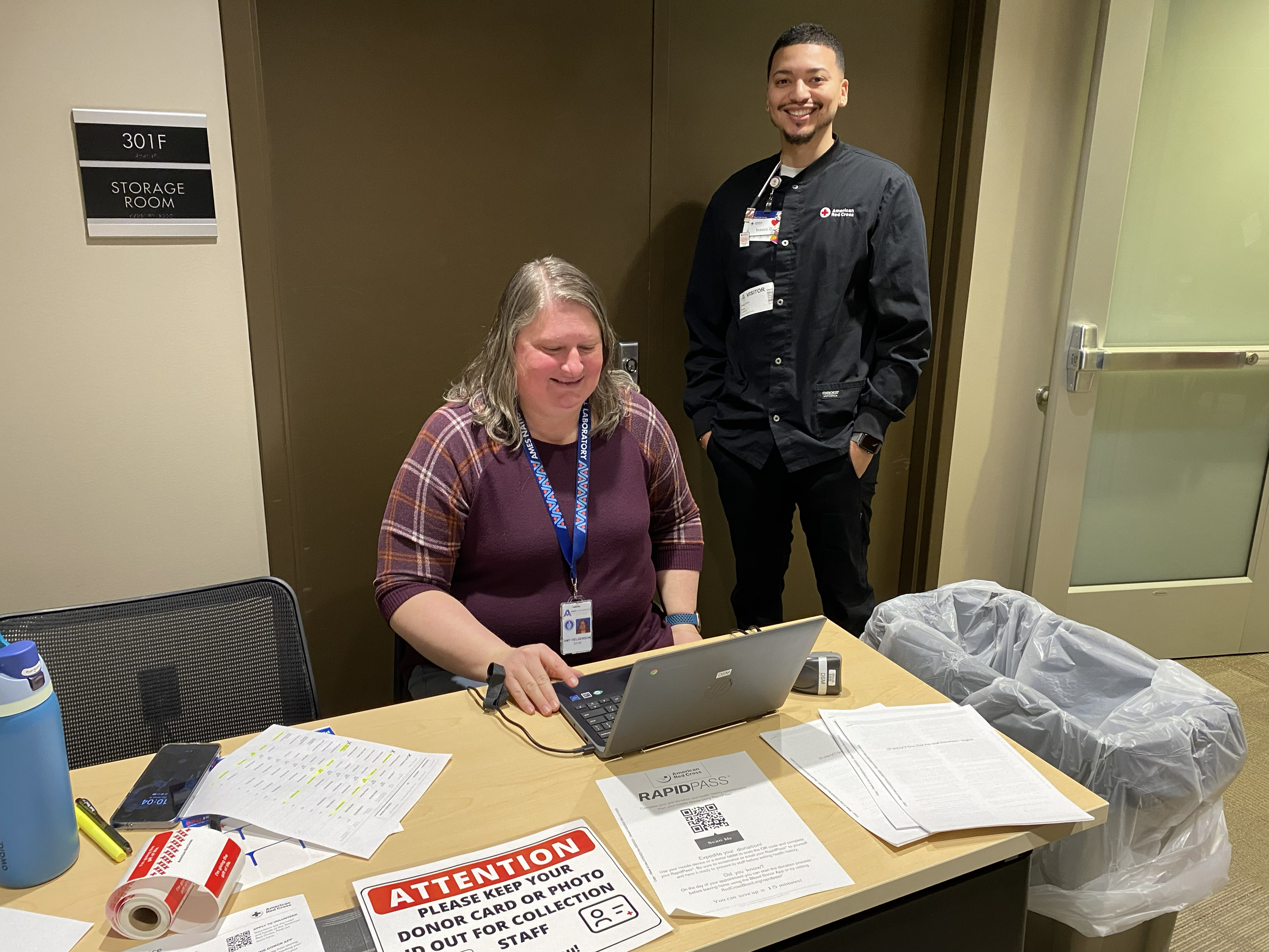 Amy and Isaac working at the registration table.