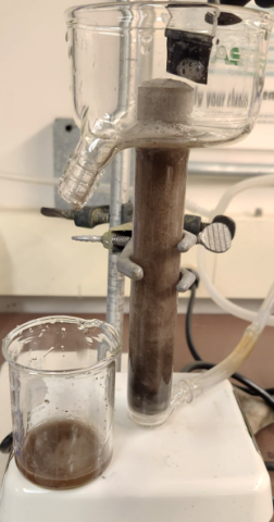 class container that pours into a glass beaker