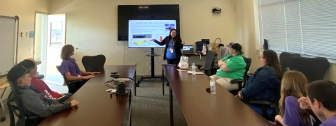 image of person presenting to group of people