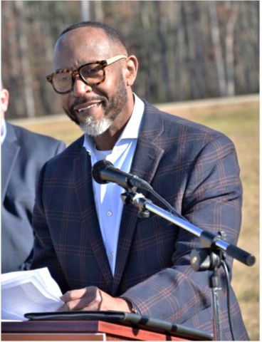 image of person standing at podium with microphone
