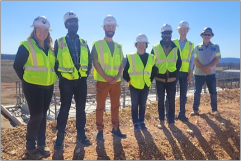 group of people wearing hard hats and safety vests
