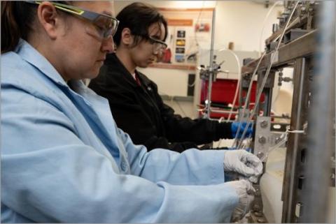 Post Masters and Post Doctorate fellows Willow Hasley-Velez (back) and Elizabeth Garcia (front) collect samples of LREE and HREE concentrates and purified organic solvent
