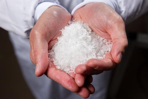 hands holding shredded plastic waste