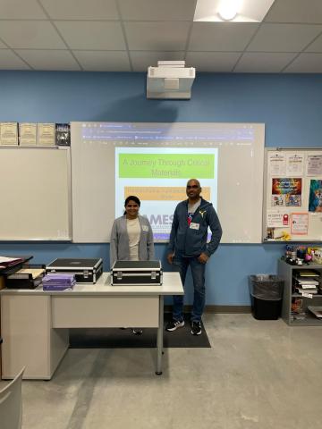 two people standing in a classroom