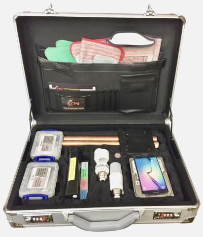 image of a briefcase with tools, including a set of copper tubes, magnets and ball bearings