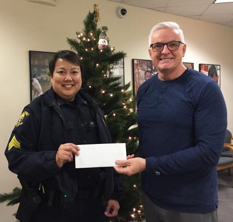 Ames Police officer receiving auction proceeds