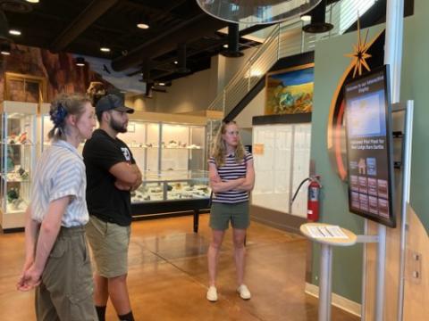 photo of three people standing in the CMI exhibit at the Colorado School of Mines Museum of Earth Science 