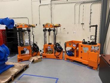 In the critical materials recovery and circular economy research laboratory, hydraulic presses configured to study rare earth permanent magnet extraction from rotors.