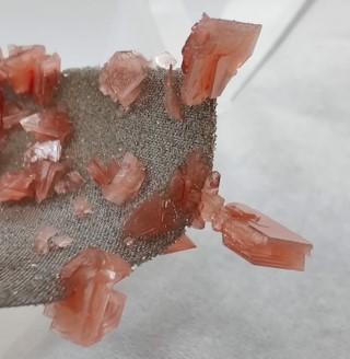 image of orange crystals on gray rock