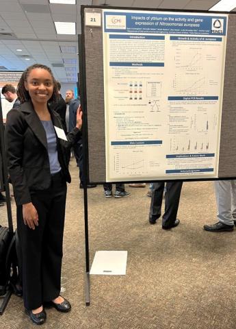 image of woman standing by a research poster