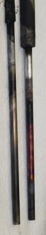 image shows two slender rods with varying amounts of sediment (these are anodes after cleaning)