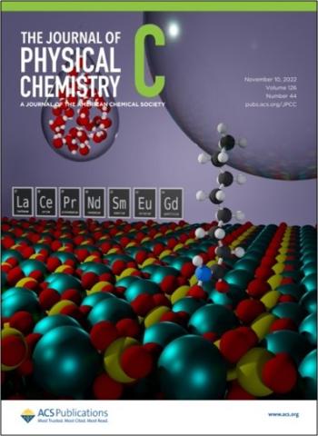 Journal cover depicting water adsorption and an adsorbed ligand bridging from monazite-{100} to an air bubble.