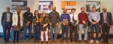 group of people standing in front of banners, are the members of the CMI Leadership Academy, Cohort 4, honored during the CMI Winter Meeting in January 2023