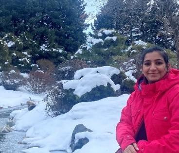 image of person in red coat with snow and trees, CMI postdoc Sandeep Kaur, Oak Ridge National Laboratory