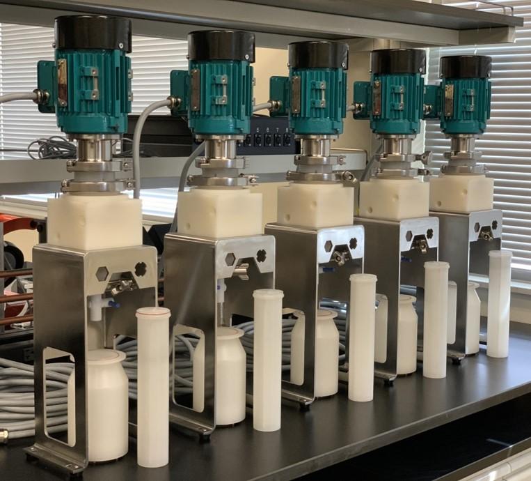 5-stage centrifugal contactor system at INL. Extended mixing sleeves and rotors shown below each unit.
