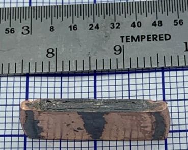 After process, thin bulk magnet enveloped by a copper shell providing mechanical support and corrosion protection.
