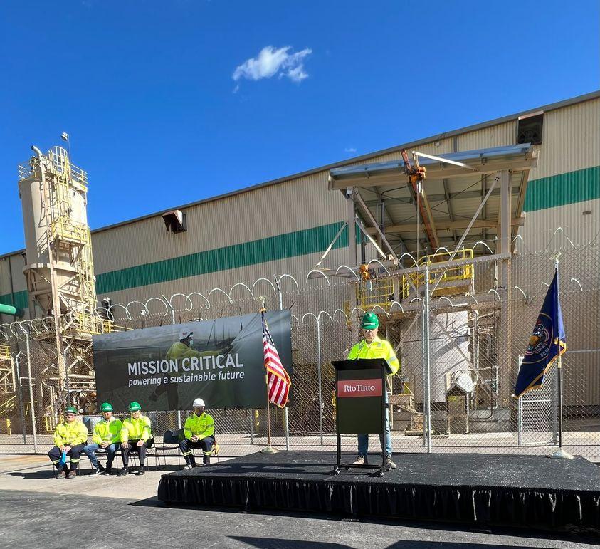 person at podium in front of large building for Rio Tinto announcement of producing tellurium