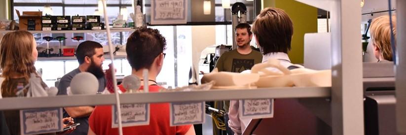 Photo of students attending event tour the Advanced Manufacturing laboratory.