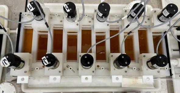 image of laboratory equipment: Counter-current mixer settlers filled with TGDGA-6 solvent; contacted with light rare earth element feed in 4 M hydrochloric acid.