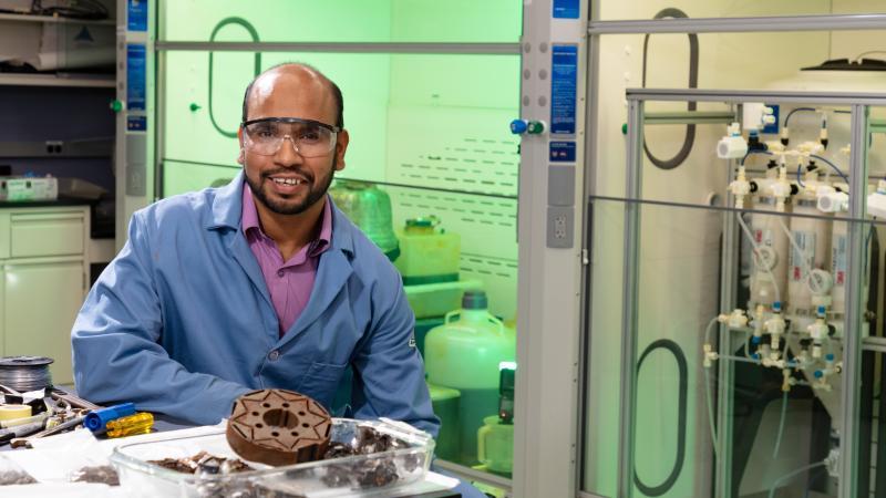 image of person in a research laboratory: Syed Islam co-invented a process to recover rare earth elements from scrap magnets. Under a new licensing agreement, Islam and colleague Ramesh Bhave will apply their technology to mined ores. Credit: Carlos Jones/ORNL, U.S. Dept. of Energy