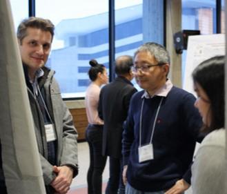 image of several people standing next to research posters