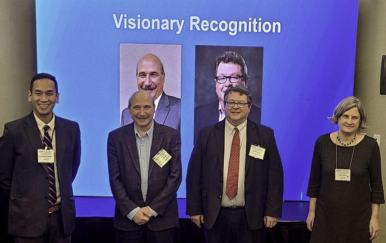 image of four people standing in a row