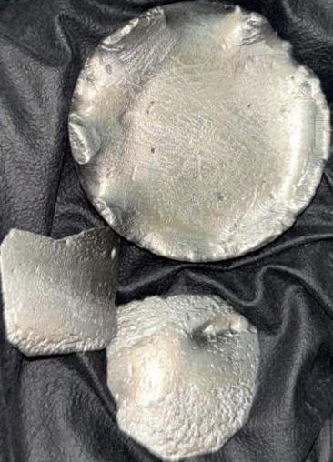 image of metal samples: About 55 g of Dysprosium metal obtained after calciothermic reduction of 100g of sodium dysprosium tetrafluoride (NaDyF4) compound.