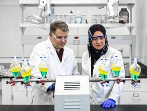 image of two people wearing protective gear in a research laboratory
