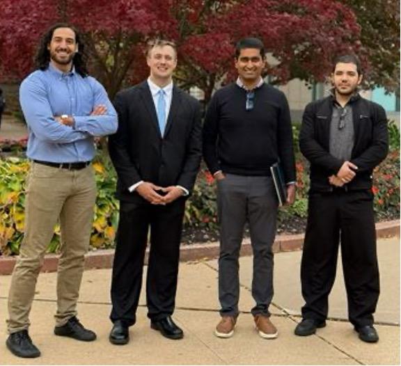 four people standing, including CMI Project Lead Rohan Akolkar (third from left) with Ben Holcombe (second from left).