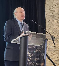image of person standing at podium: Thomas Lograsso, Ames National Laboratory